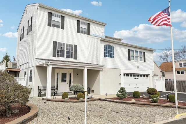 415 Lorillard Ave, Union Beach, NJ 07735 - view of front of property featuring fence, stucco siding, a porch, and a garage