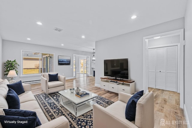 living room featuring a baseboard heating unit, recessed lighting, visible vents, and light wood-style floors