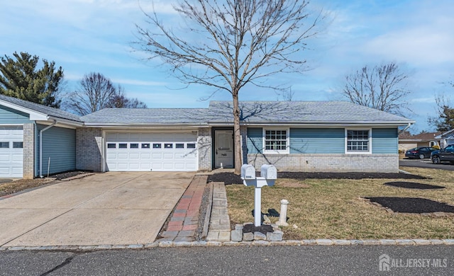 single story home with concrete driveway, brick siding, an attached garage, and a front yard