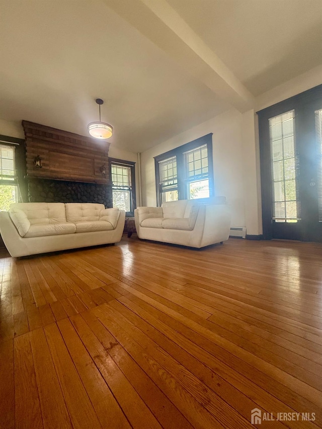 451 E Main St, Somerville, NJ 08876 - unfurnished living room with wood-type flooring, baseboard heating, and plenty of natural light
