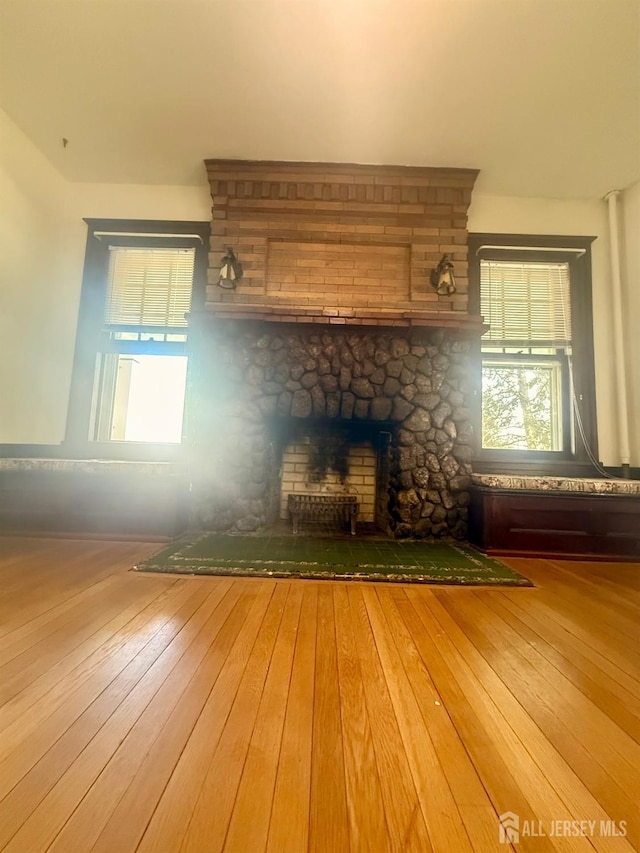 451 E Main St, Somerville, NJ 08876 - unfurnished living room with hardwood / wood-style flooring and a stone fireplace