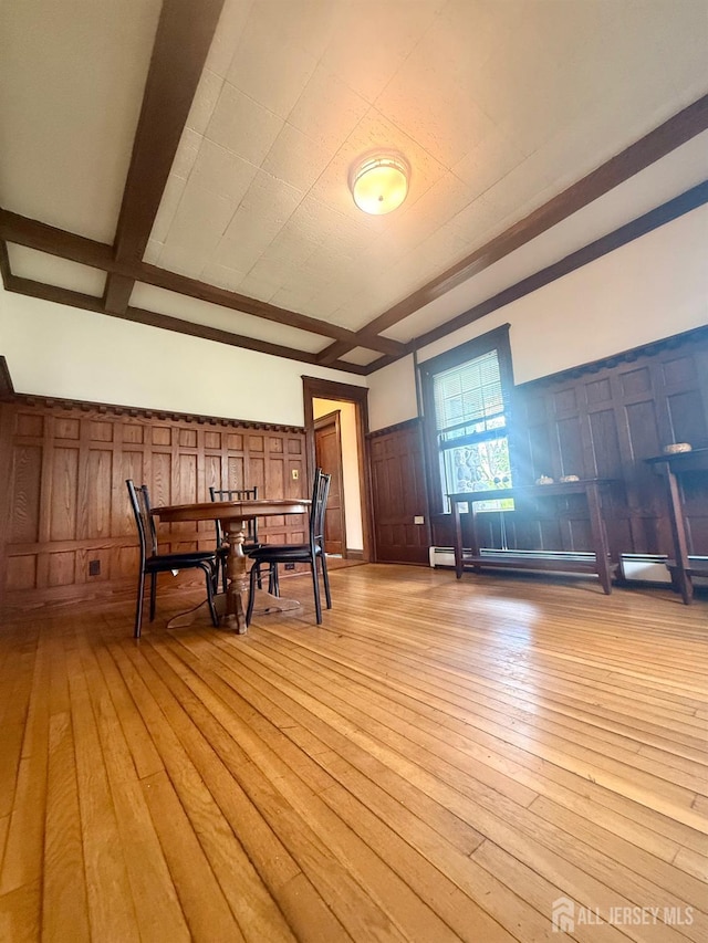 451 E Main St, Somerville, NJ 08876 - unfurnished dining area with a decorative wall, light wood-style flooring, a wainscoted wall, and beamed ceiling