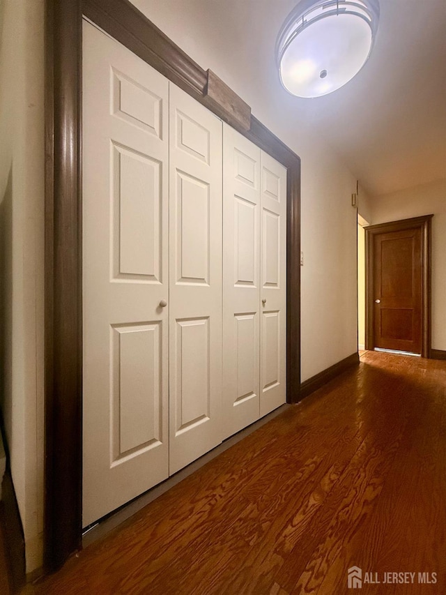 451 E Main St, Somerville, NJ 08876 - unfurnished bedroom with dark wood-style flooring, baseboards, and a closet