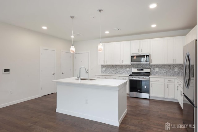 kitchen featuring visible vents, backsplash, appliances with stainless steel finishes, white cabinetry, and a sink