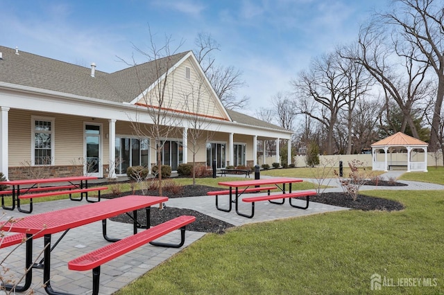 surrounding community featuring a gazebo, a lawn, and fence