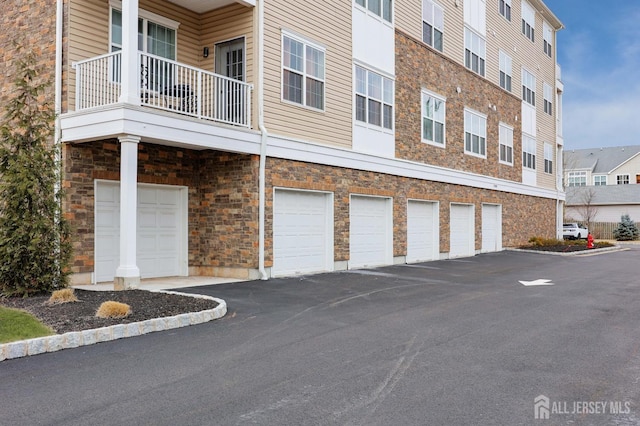 view of building exterior featuring community garages