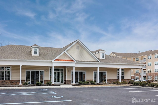 view of building exterior with uncovered parking