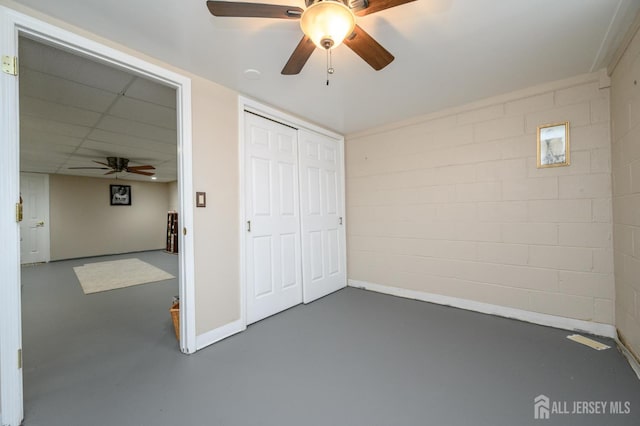 17 Duane St, Jamesburg, NJ 08831 - unfurnished bedroom with concrete flooring, concrete block wall, ceiling fan, and a closet