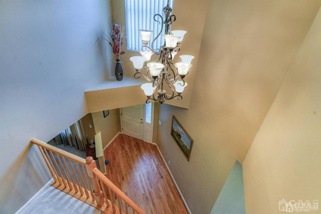 18 Bucknell Dr, East Brunswick, NJ 08816 - stairs featuring baseboards, an inviting chandelier, and wood finished floors