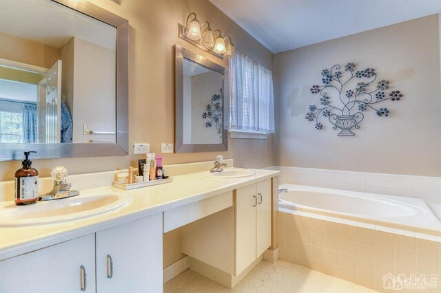 18 Bucknell Dr, East Brunswick, NJ 08816 - bathroom with double vanity, tile patterned floors, a sink, and a garden tub