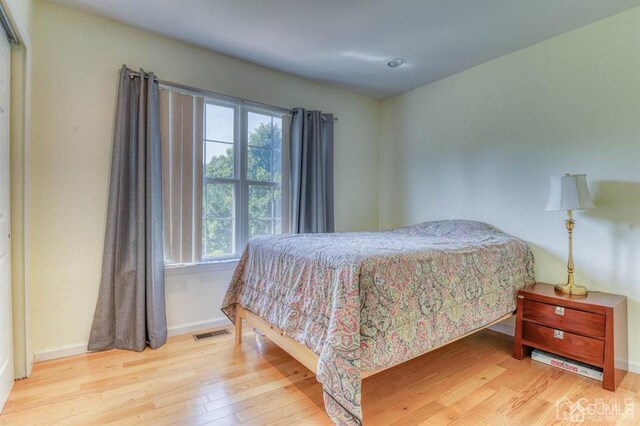 18 Bucknell Dr, East Brunswick, NJ 08816 - bedroom with baseboards, visible vents, multiple windows, and wood finished floors