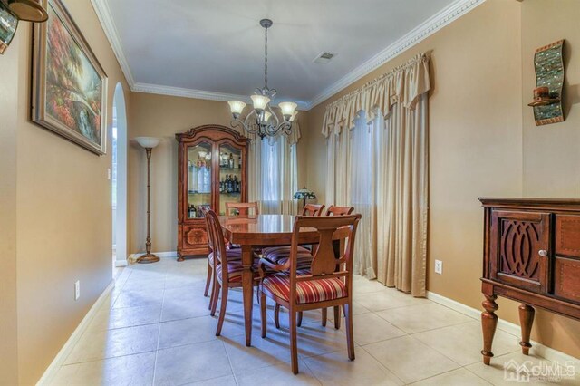 18 Bucknell Dr, East Brunswick, NJ 08816 - dining area with an inviting chandelier, baseboards, ornamental molding, and visible vents