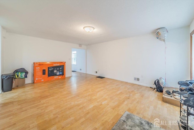 36 Henry St, Edison, NJ 08820 - unfurnished living room with light wood-type flooring and a textured ceiling