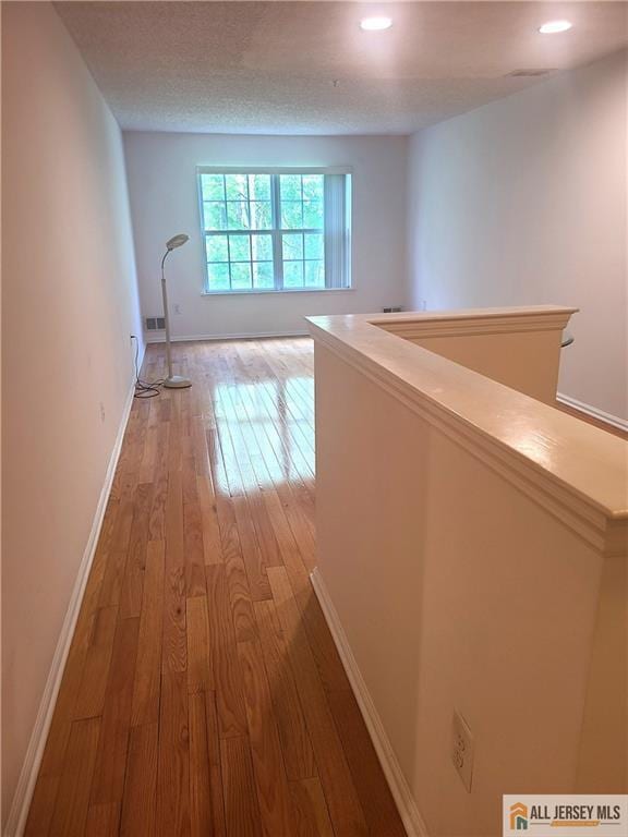 297 Prestwick Way Unit 297, Edison, NJ 08820 - hall with light wood-style flooring, baseboards, an upstairs landing, and recessed lighting