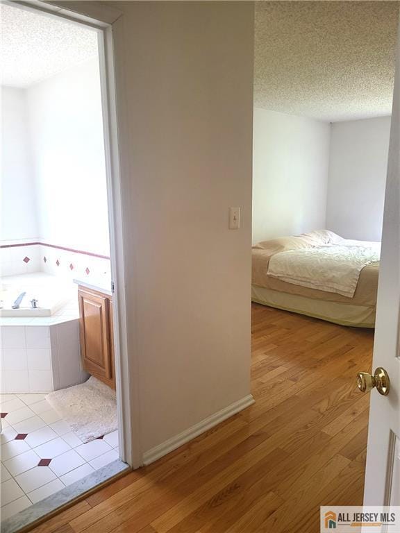 297 Prestwick Way Unit 297, Edison, NJ 08820 - bedroom with a textured ceiling and wood finished floors