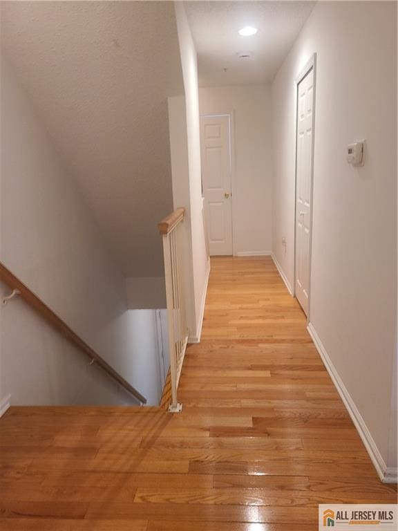 297 Prestwick Way Unit 297, Edison, NJ 08820 - hall with an upstairs landing, light wood-type flooring, and baseboards