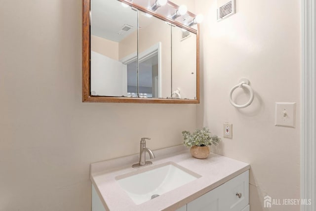 bathroom featuring vanity and visible vents