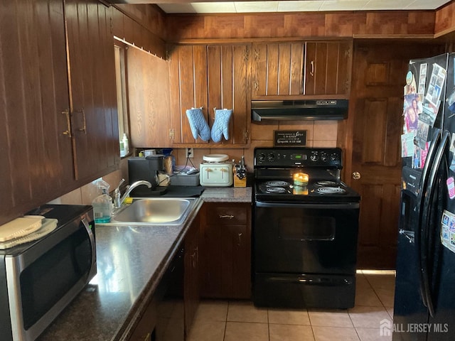 kitchen with sink, light tile patterned floors, and black appliances