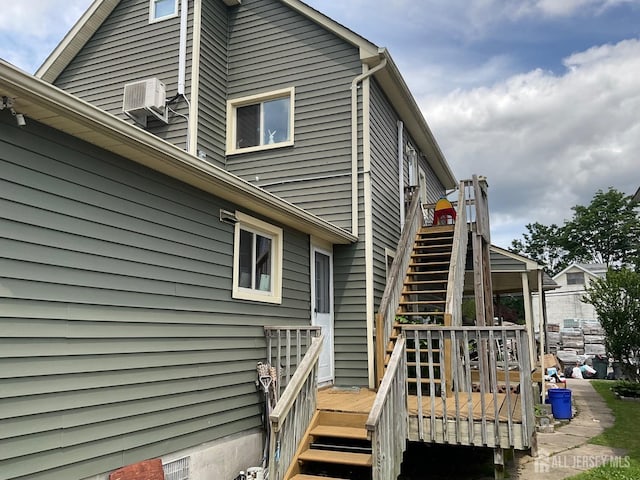 back of house featuring a wall mounted air conditioner