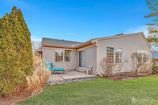 rear view of house featuring a patio area and a yard