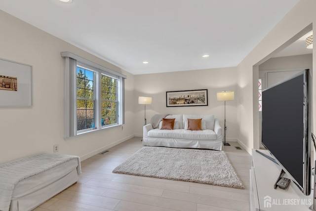 bedroom featuring baseboards, visible vents, and light wood-style floors