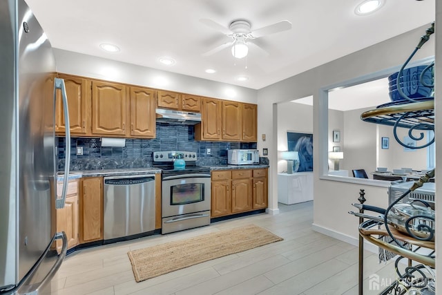 8 John Paul Jones Dr Unit 8A, Monroe, NJ 08831 - kitchen with appliances with stainless steel finishes, under cabinet range hood, ceiling fan, tasteful backsplash, and brown cabinetry
