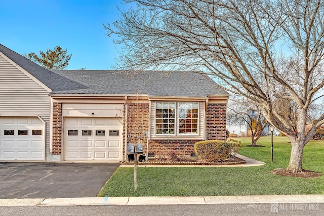 view of front of home featuring a garage, brick siding, a front yard, and aphalt driveway