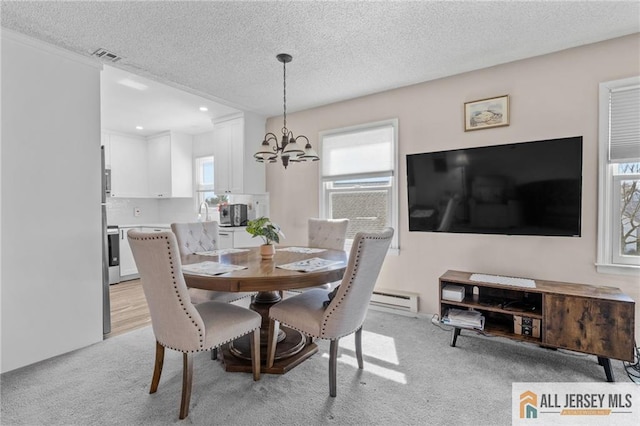 479 Newport Way, Monroe, NJ 08831 - dining room with a chandelier, light carpet, a textured ceiling, healthy amount of natural light, and recessed lighting