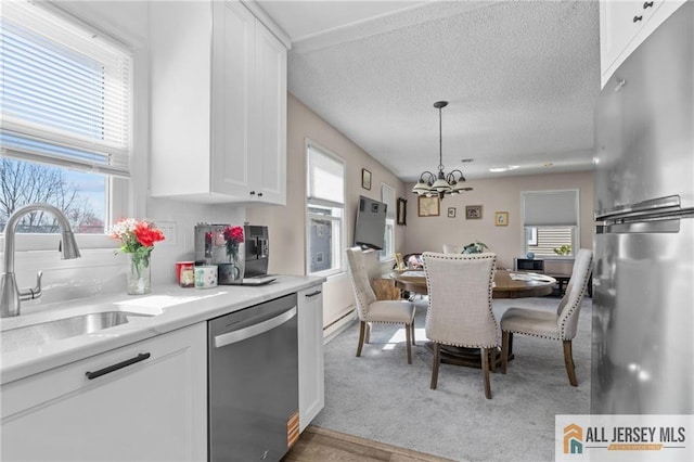 479 Newport Way, Monroe, NJ 08831 - kitchen with appliances with stainless steel finishes, a sink, a chandelier, white cabinetry, and healthy amount of natural light