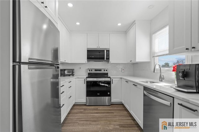 479 Newport Way, Monroe, NJ 08831 - kitchen featuring stainless steel appliances, a sink, white cabinetry, dark wood finished floors, and recessed lighting