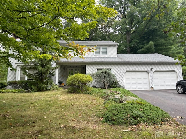 view of front property with a front lawn and a garage