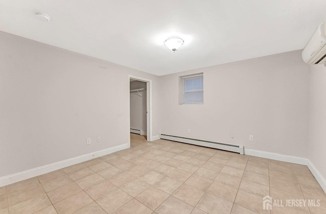 empty room with a wall mounted air conditioner and baseboard heating