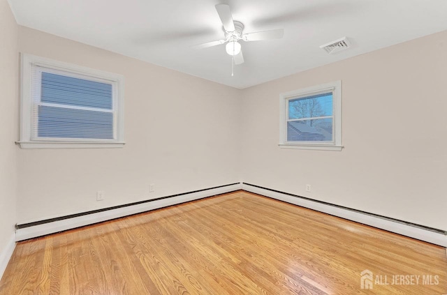 spare room with light hardwood / wood-style flooring and ceiling fan