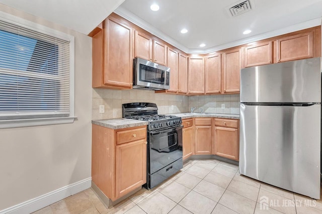 kitchen with light tile patterned floors, decorative backsplash, sink, and appliances with stainless steel finishes