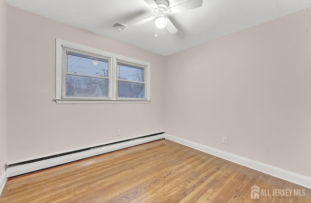 unfurnished room featuring ceiling fan, a baseboard heating unit, and light hardwood / wood-style floors