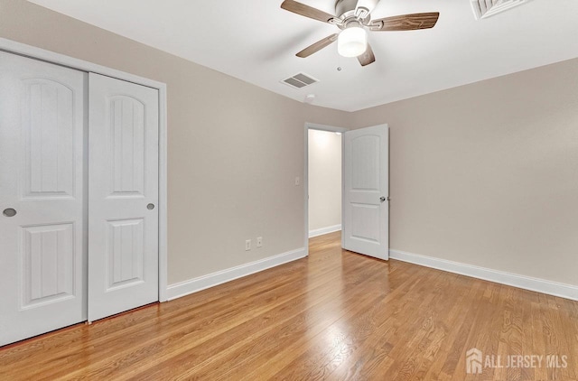 unfurnished bedroom featuring a closet, ceiling fan, and light wood-type flooring