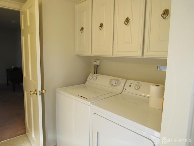 laundry room featuring washing machine and dryer and cabinet space