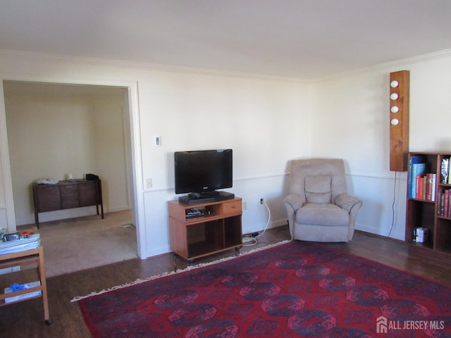 living area with dark wood-type flooring and crown molding