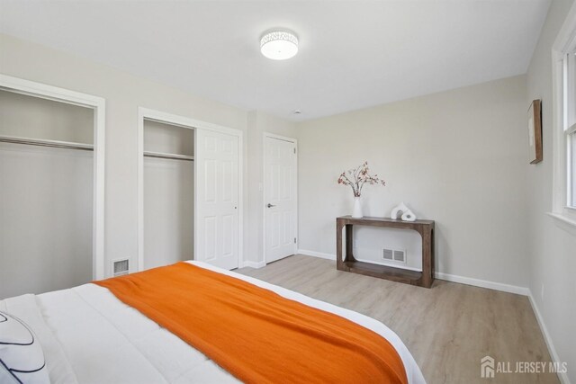 1779 Hughes Ter, Piscataway, NJ 08854 - bedroom with wood finished floors, baseboards, and multiple closets