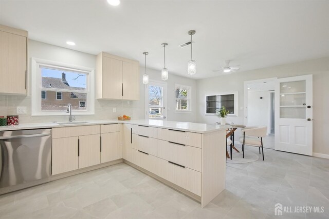 1779 Hughes Ter, Piscataway, NJ 08854 - kitchen with dishwasher, a sink, light brown cabinets, a peninsula, and plenty of natural light