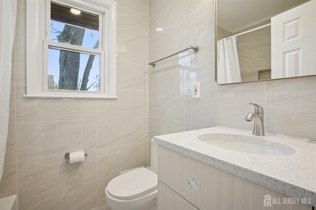 1779 Hughes Ter, Piscataway, NJ 08854 - bathroom featuring tile walls, vanity, toilet, a shower with shower curtain, and decorative backsplash