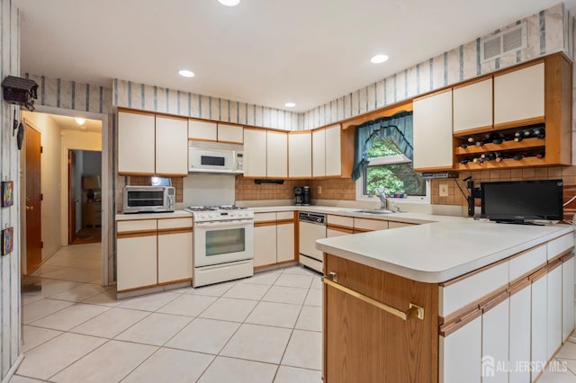 20 Buffalo Run, East Brunswick, NJ 08816 - kitchen featuring white appliances, light countertops, a peninsula, backsplash, and recessed lighting
