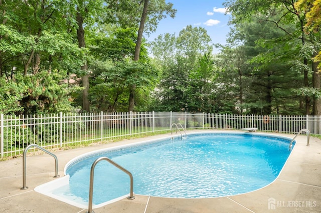20 Buffalo Run, East Brunswick, NJ 08816 - view of pool with a fenced backyard, a diving board, view of scattered trees, and a patio