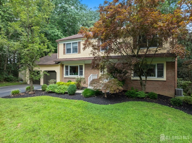 20 Buffalo Run, East Brunswick, NJ 08816 - view of front of home with a front lawn, a garage, brick siding, and driveway