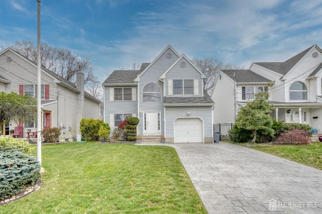 front facade featuring a front lawn and a garage