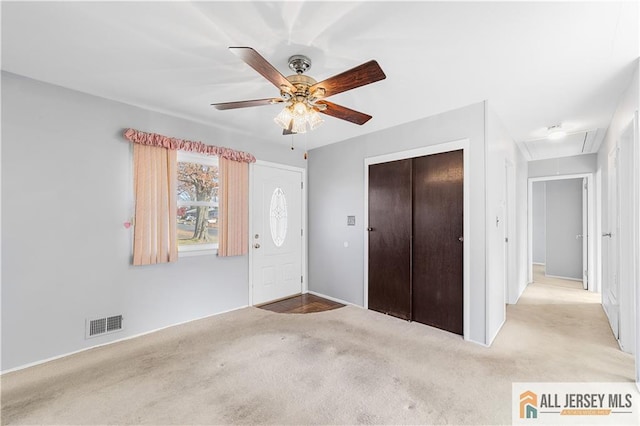 unfurnished bedroom with ceiling fan, a closet, and light carpet