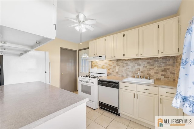 kitchen with sink, white appliances, light tile patterned flooring, ceiling fan, and tasteful backsplash