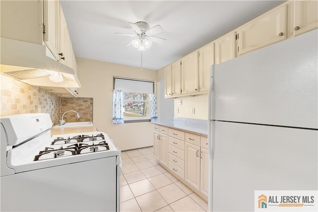 kitchen with white appliances, light tile patterned floors, decorative backsplash, ceiling fan, and sink