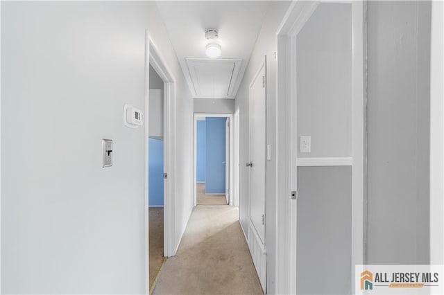 hallway featuring light colored carpet