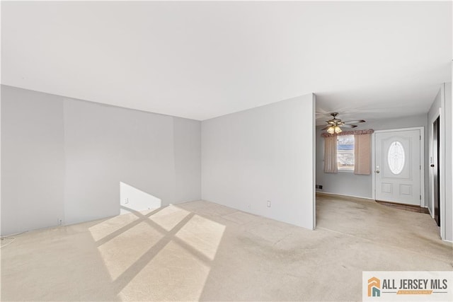 carpeted spare room with ceiling fan